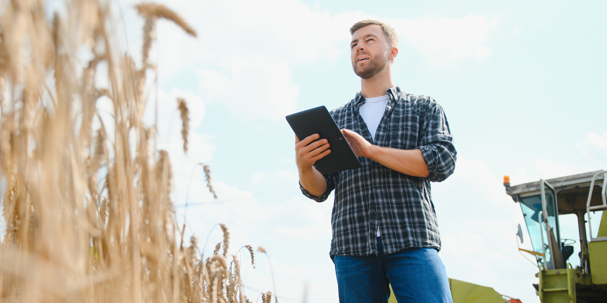 farmer-looking-at-tablet-in-corn-field-cropped